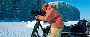 Doug Allan filming with a camera and tripod in Arctic Canada, © Doug Allan