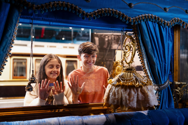 Two children looking inside a railway carriage