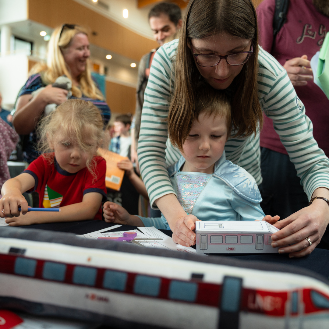 A family enjoying train craft activities