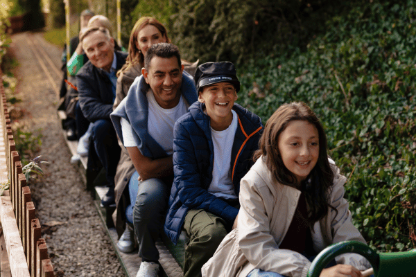 Children and adults enjoying a ride on the miniature railway