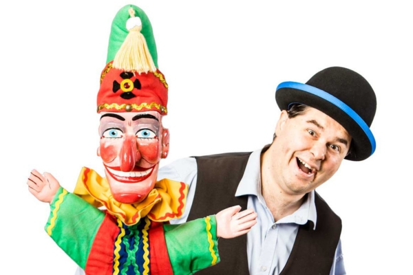 Man holding Mr Punch puppet