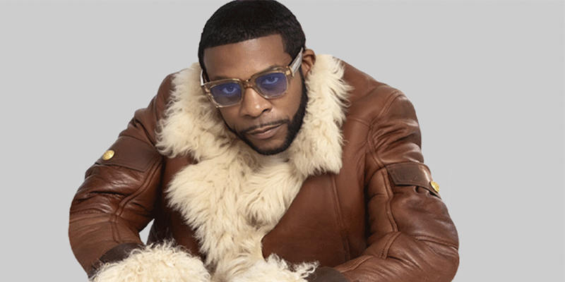 Keith wearing a brown leather jacket with fur on the collar and sleeves