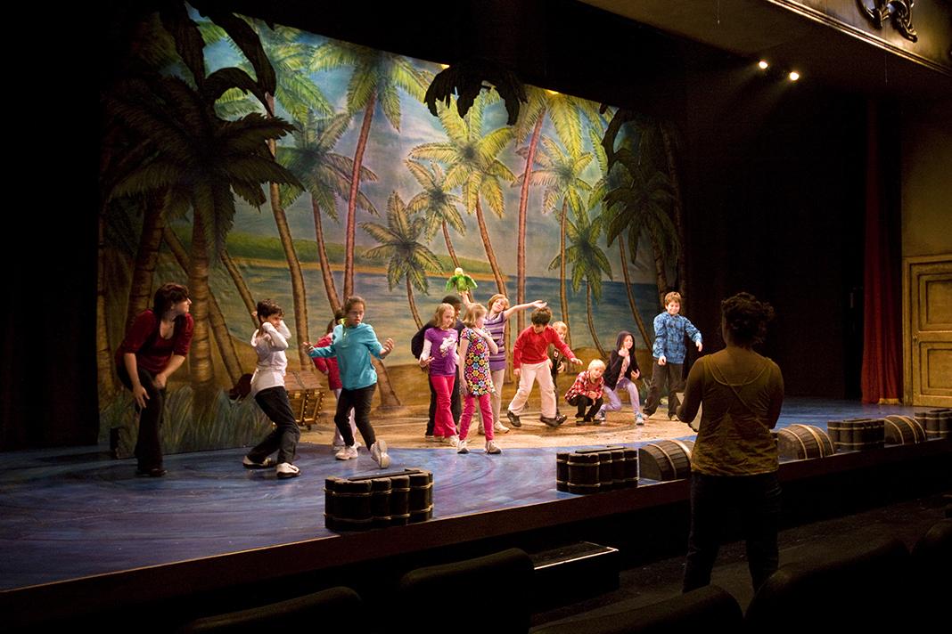 Students from General Wayne Elementary School act on stage with panto cast members