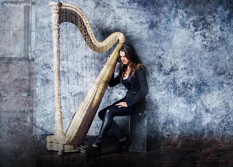 Photo of Bridget Kibbey sitting with her harp