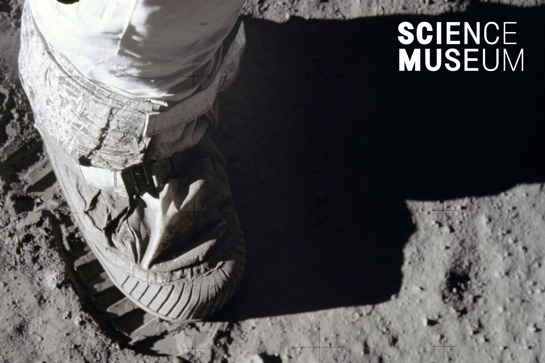 Black and white photograph of a foot in a spacesuit making a footprint on the surface of the Moon (NASA)