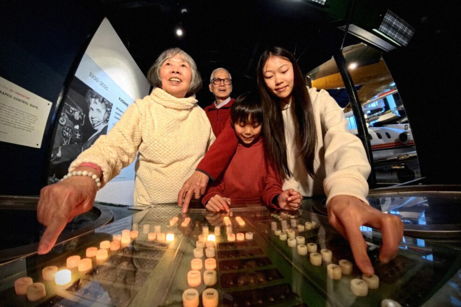 A young visitor looks at a space suit