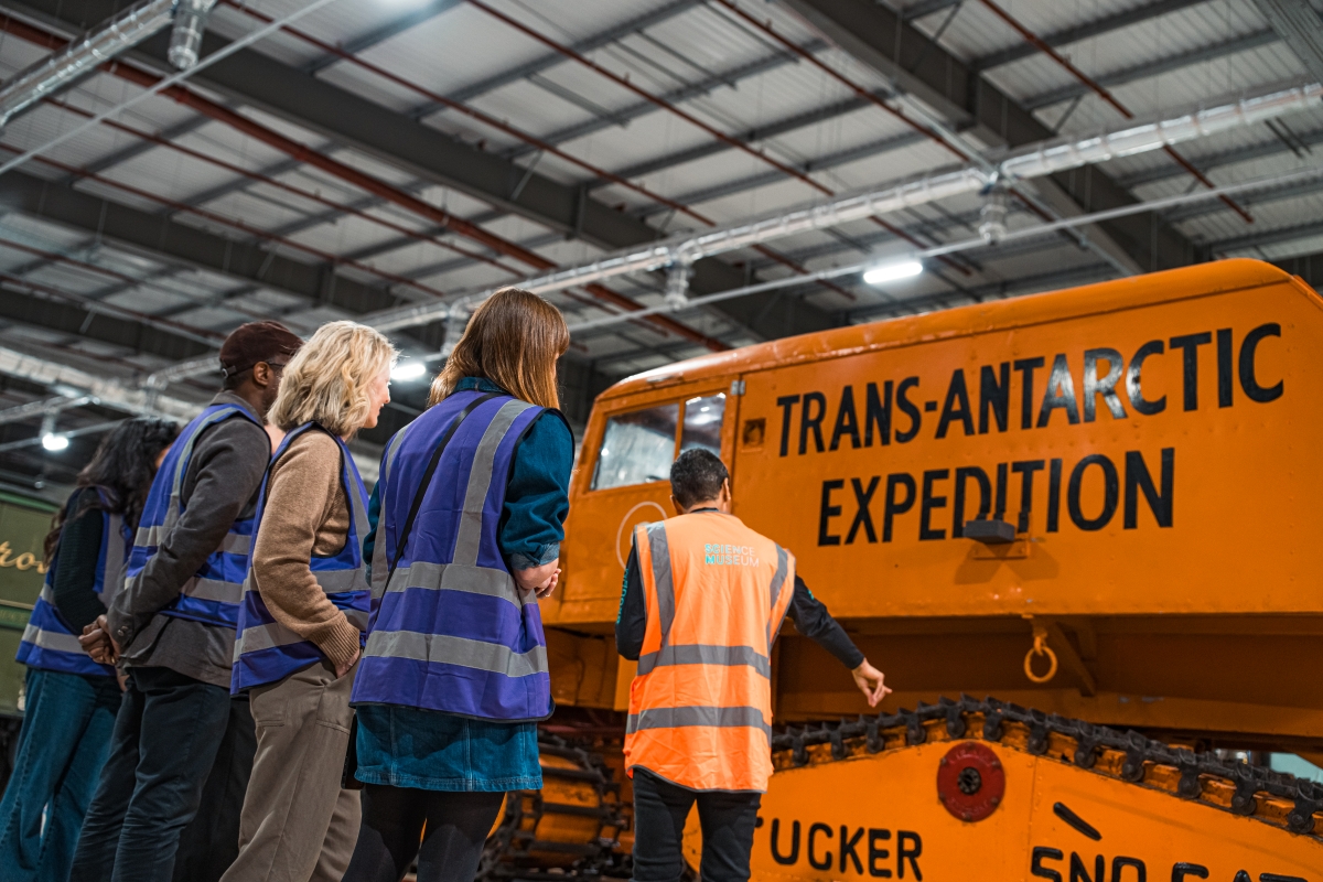 Visitors being shown the Sno-Cat vehicle by a Collections Access Facilitator