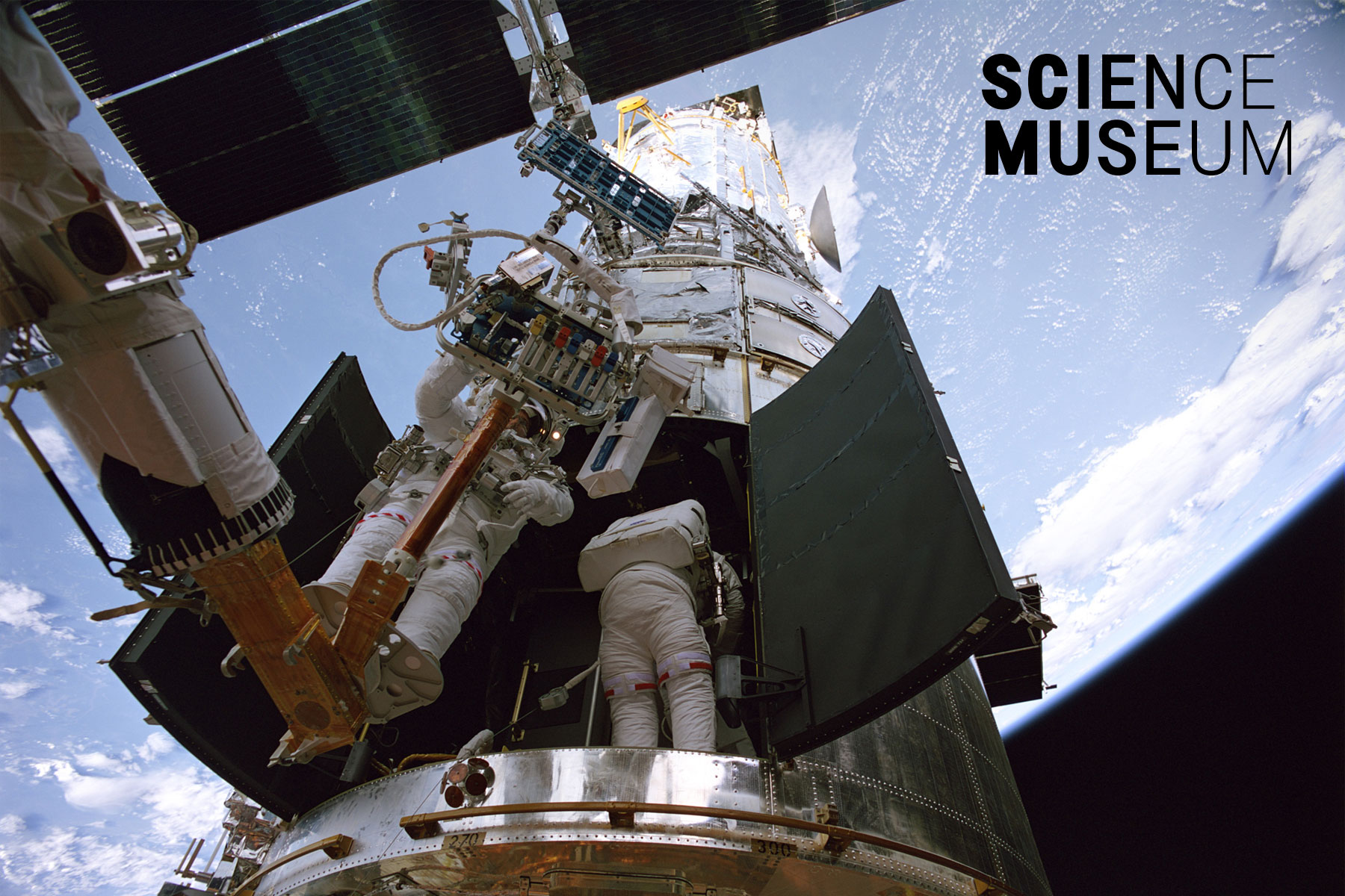 Still from the Hubble 3D IMAX film: astronauts repairing the Hubble Telescope