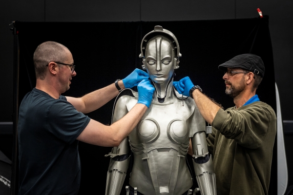 Conservator and technician caring for a robot from the Science Museum Group Collection