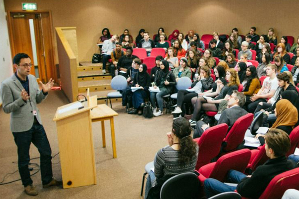 [IMAGE] Will Tosh gives a lecture to a group of students in the Nancy Knowles.