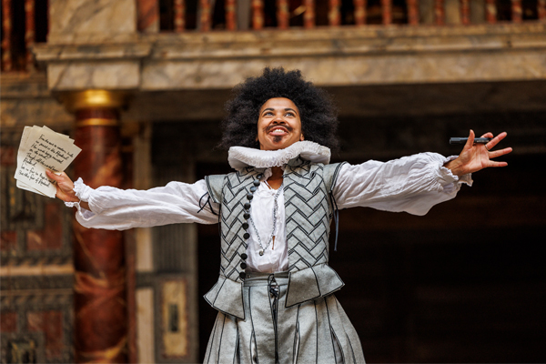 [IMAGE] An actor with arms outstretched wearing Elizabethan-inspired clothes.