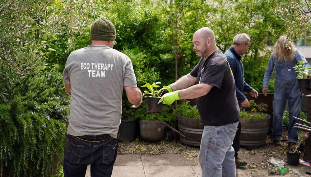 Image of Grounded Ecotherapy members gardening in the Queen Elizabeth Hall Roof Garden