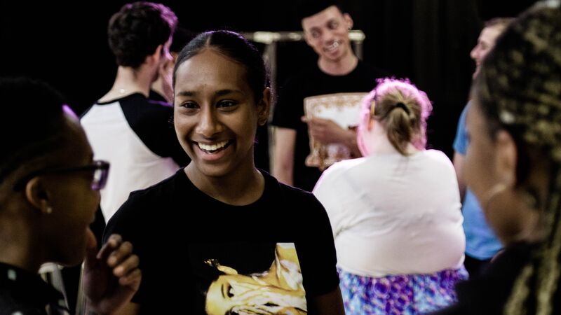 A teenage girl smiling at her friends