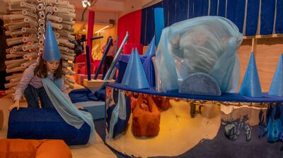 Children playing in a loose parts play installation