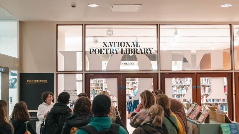 A group of people stood outside the National Poetry Library, inside the Royal Festival Hall
