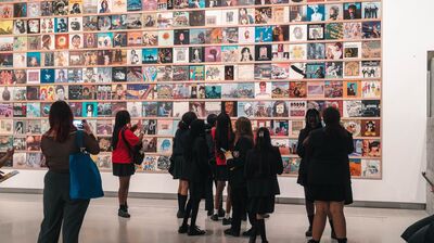A group of students stood looking at a large piece of artwork in the Hayward Gallery