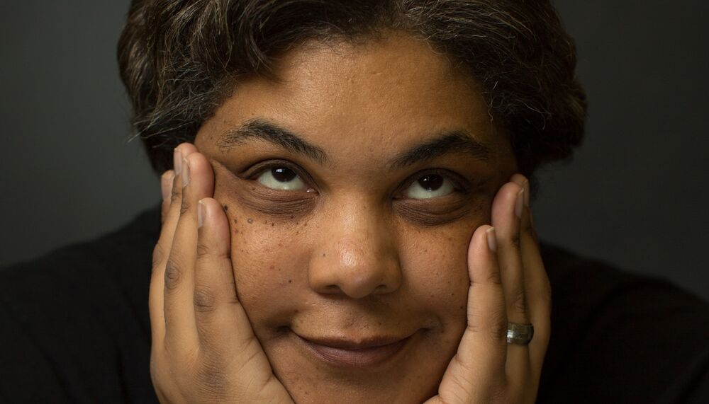 Roxanne Gay holding her face between her hands