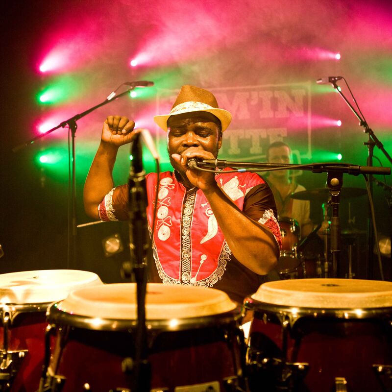 Afla Sackey, percussionist, pictured singing behind his drums