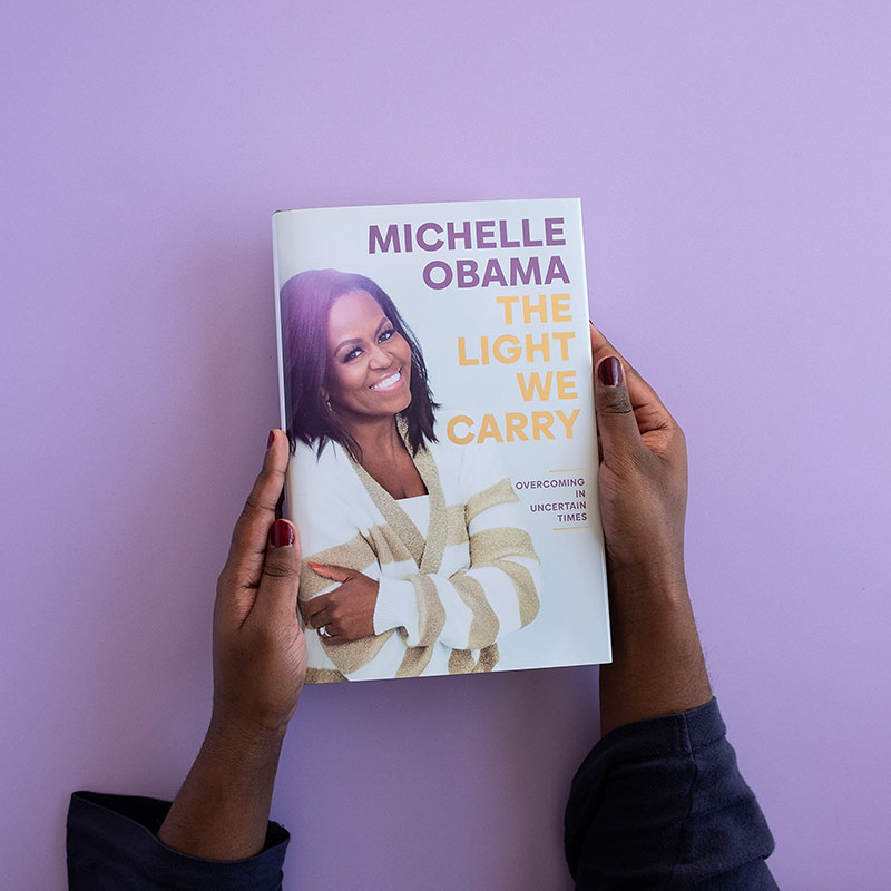 A flat lay of Michelle Obama's latest book, The Light We Carry