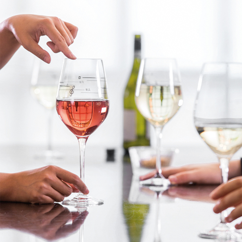 Three wine glasses being touched by three hands
