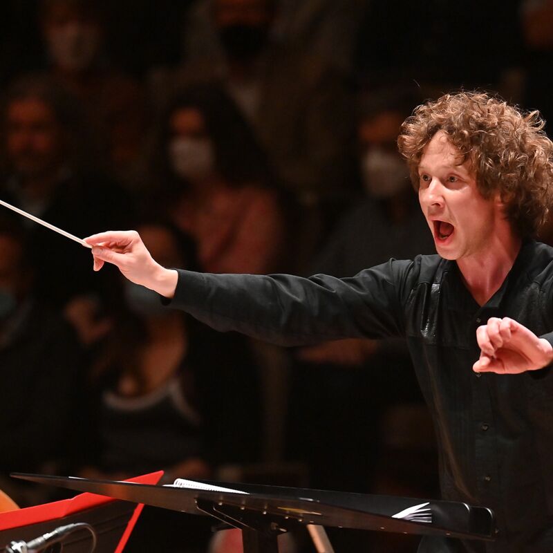 Conductor Santtu-Matias Rouvali waving his baton in the Royal Festival Hall