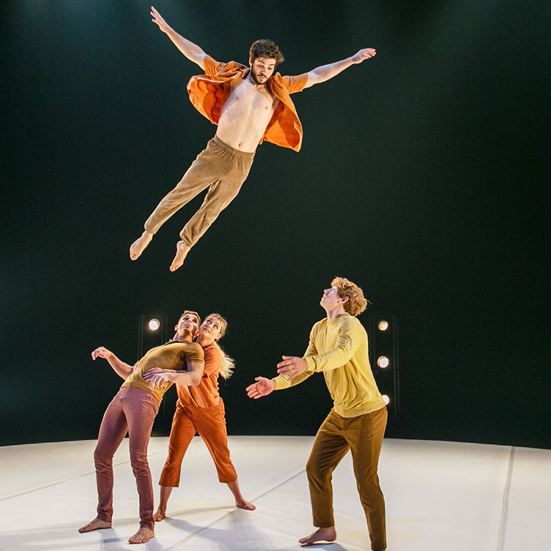 Three acrobatic performers on stage