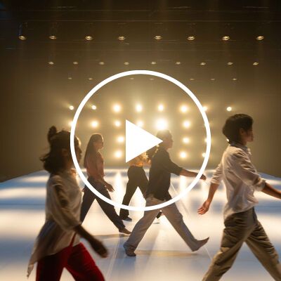 Performers on a brightly lit stage