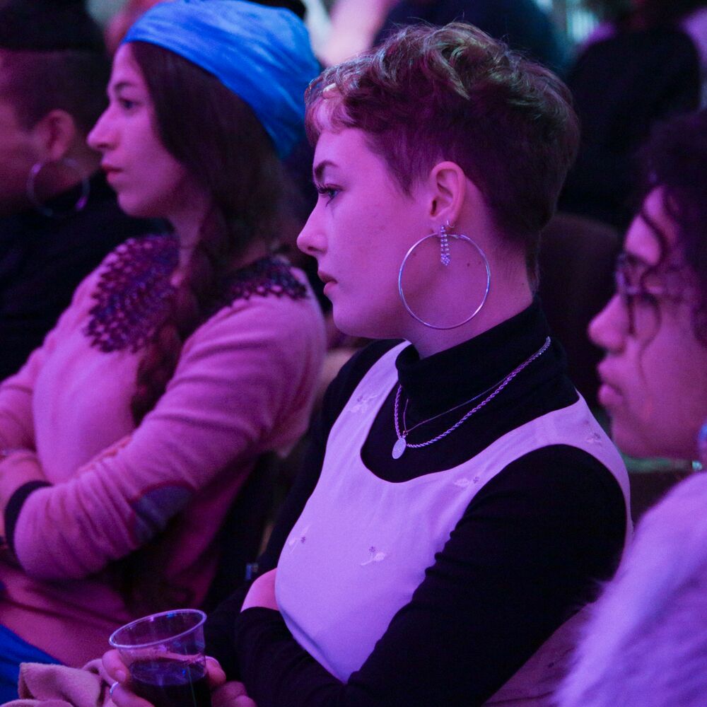 Three women in the audience looking engaged