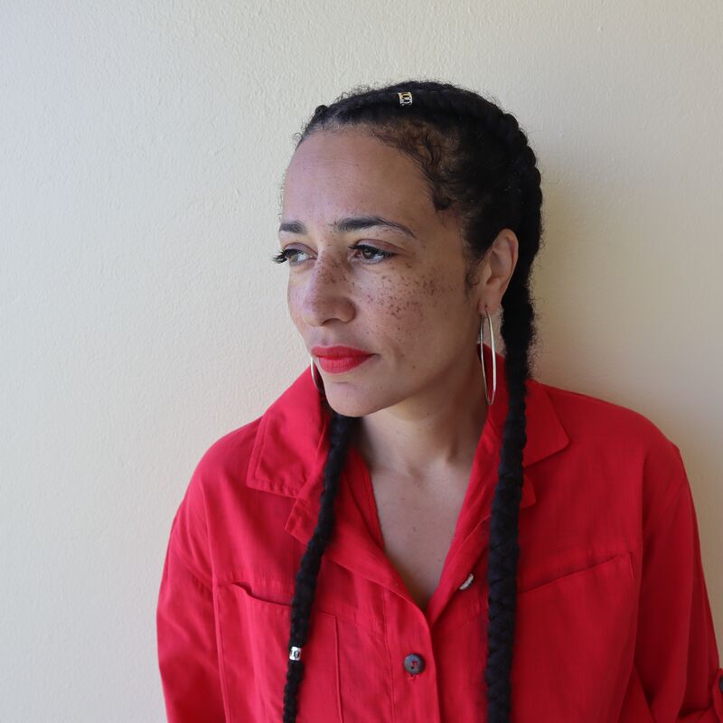 Zadie Smith photographed against a white wall