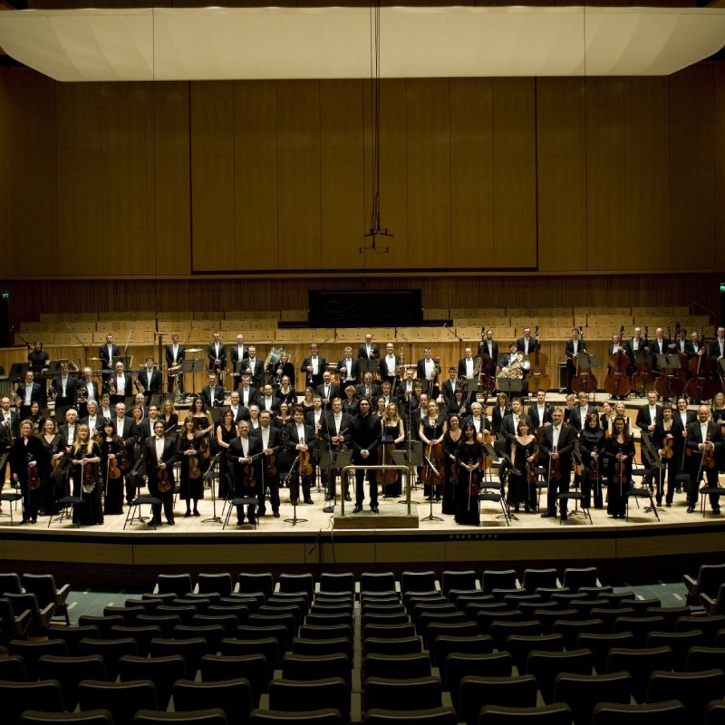 An elegant orchestra standing on stage