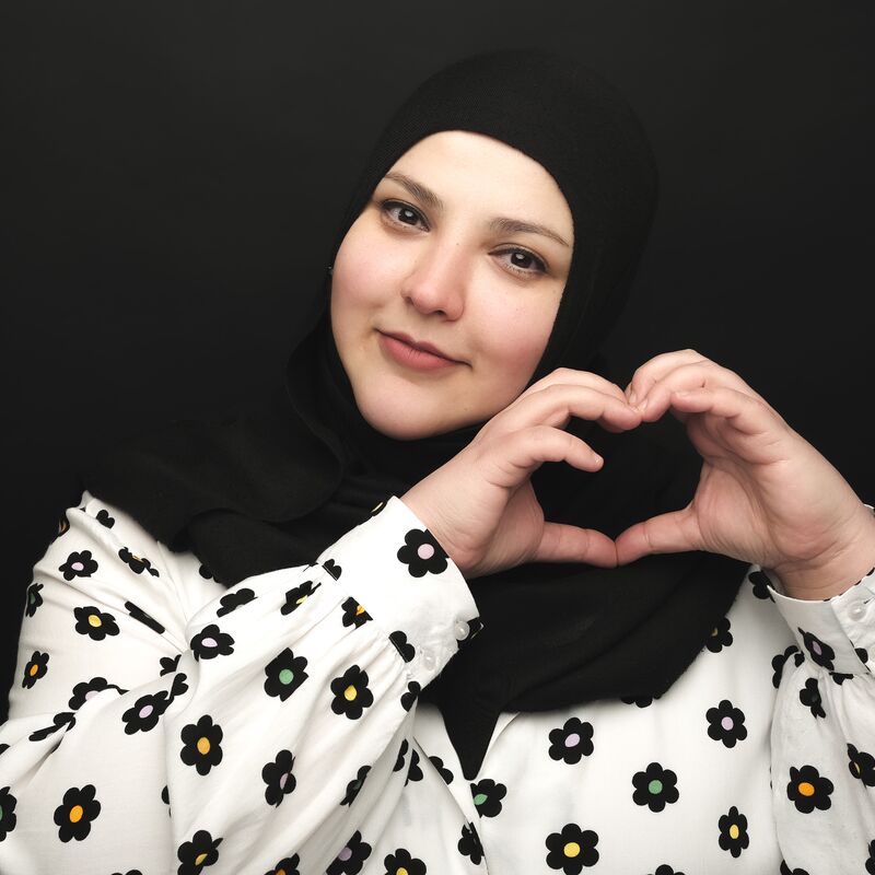 Photo of Fatiha El Ghorri making a heart shape with her hands.