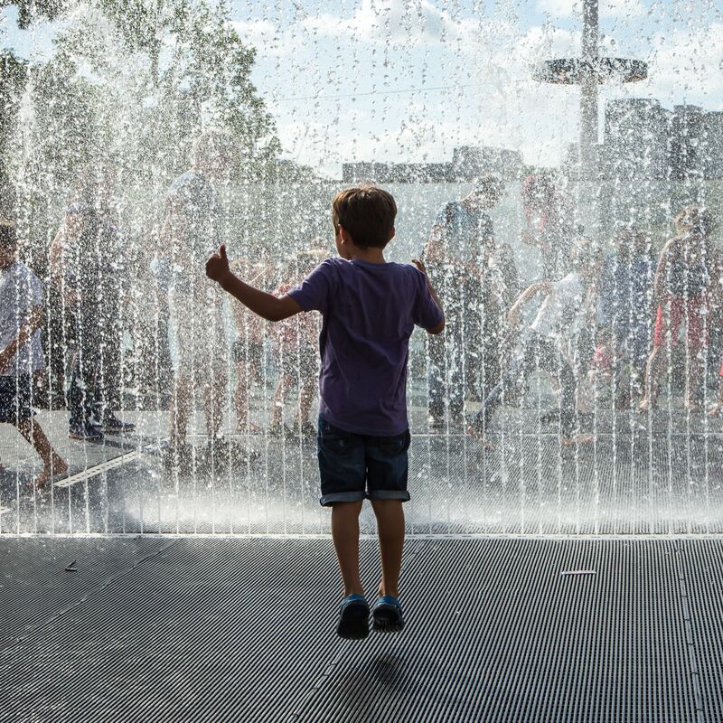 Children jumping in Jeppe Hein's Appearing Room Fountains