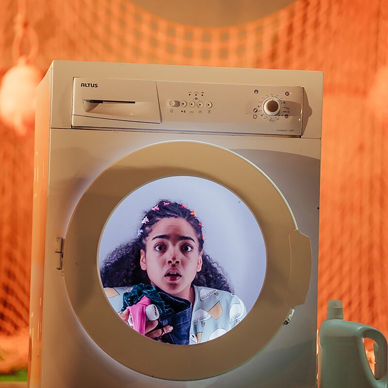 An actress looking out of a washing machine