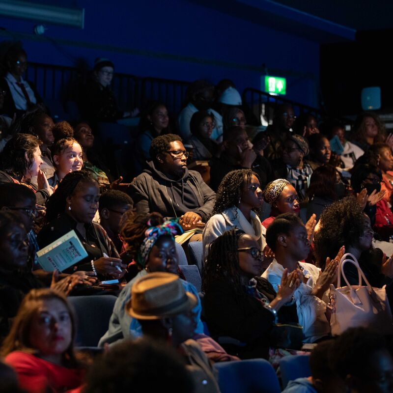 The audience of the Black British Book Festival wait in anticipation for an event to start.