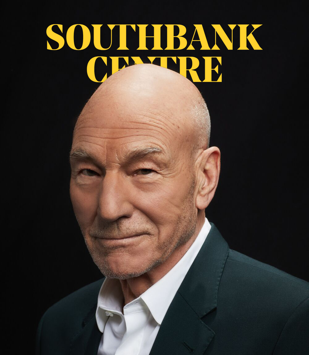 Patrick Stewart wears a sharp, dark suit over a white shirt and is pictured smiling to camera at a three quarter angle. He is bald with a faint stubble and blue eyes.