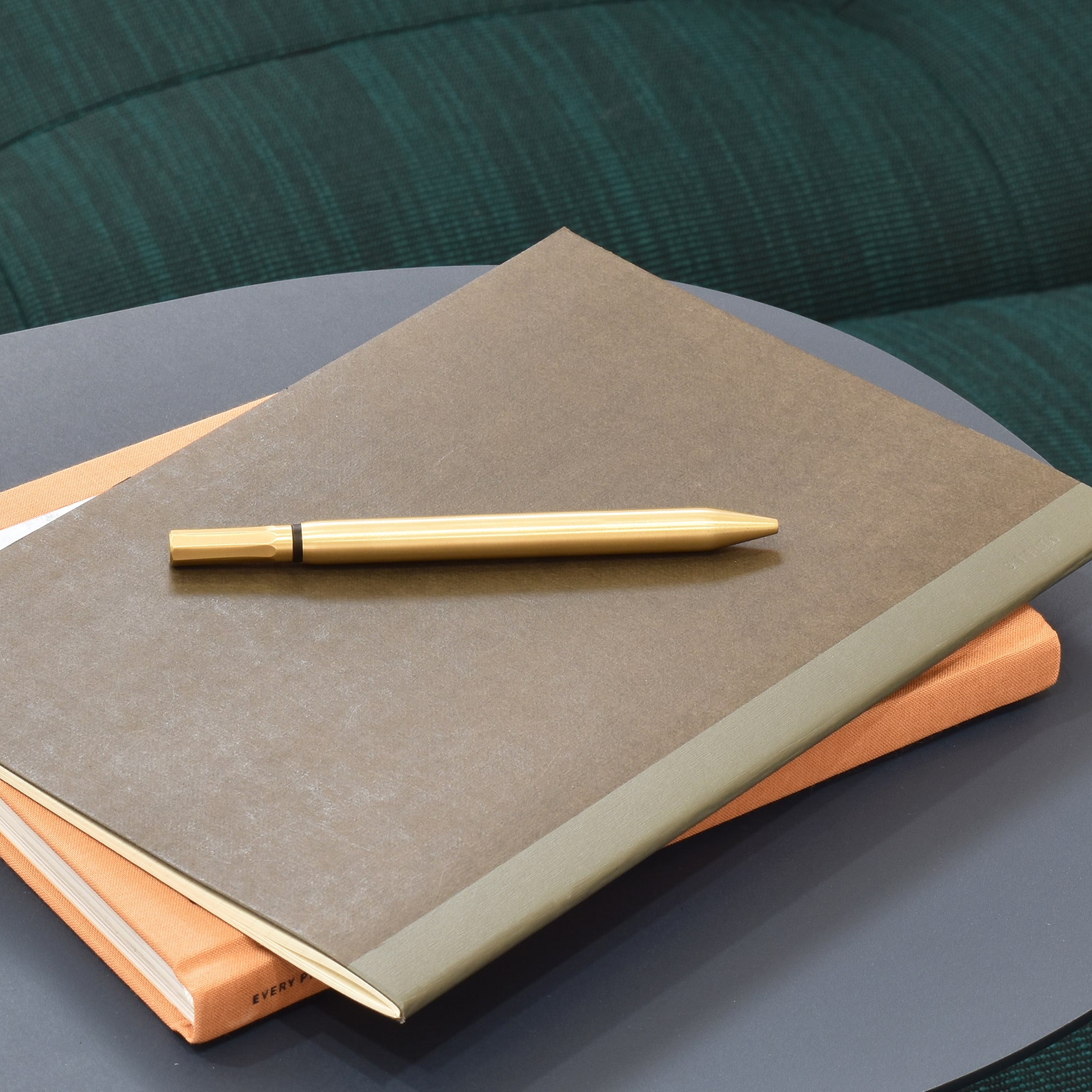 A set of notebooks and a pen