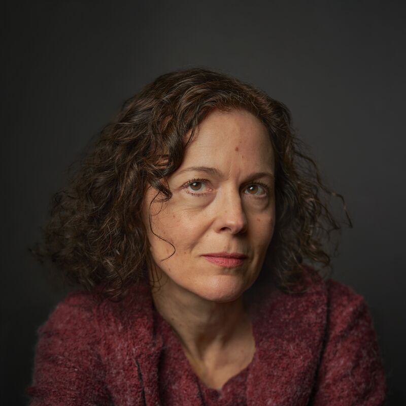 Headshot of Sandra Newman wearing a burgundy cardigan