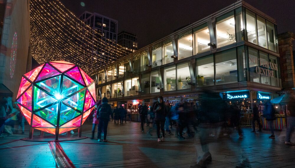 Jakob Kvist 's Dichroic Sphere on site at Southbank Centre . The sphere is illuminated from within and shines with many colours.