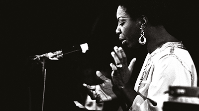 An image of nina simone singing in black and white