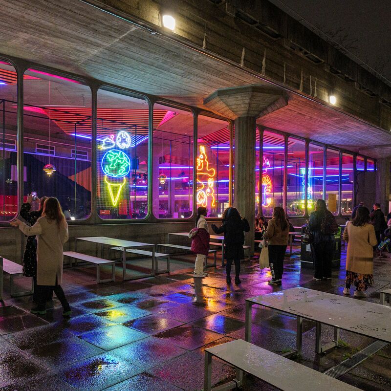 Neon lights above the tables outside the Queen Elizabeth Hall