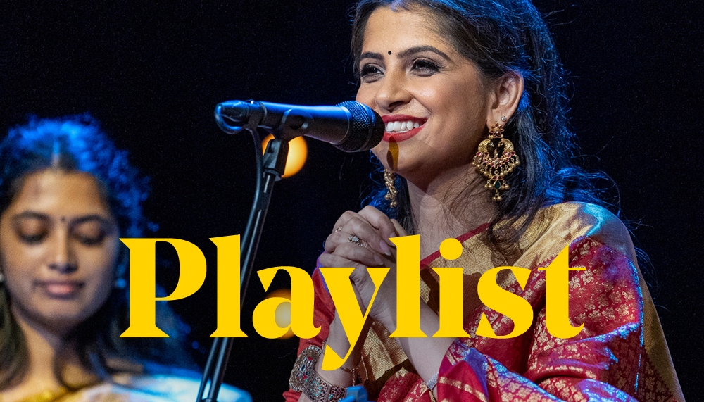 Kaushiki Chakraborty wearing a red sari sitting in front of a microphone. The word ‘Playlist’ is placed over the top of the image in yellow type.