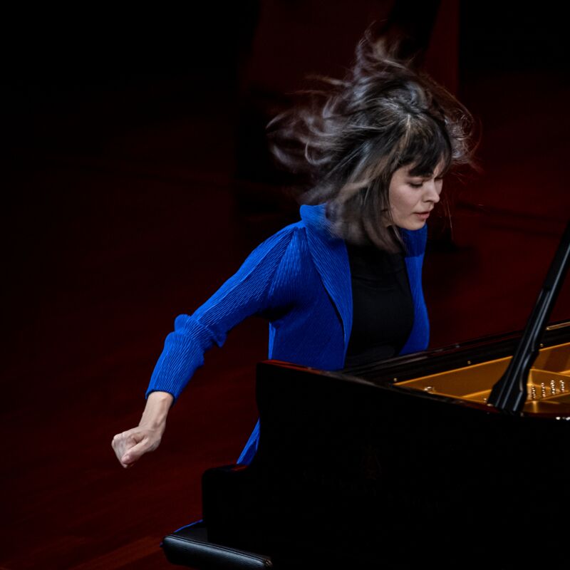 Alice Sara Ott playing the piano with her hair in motion