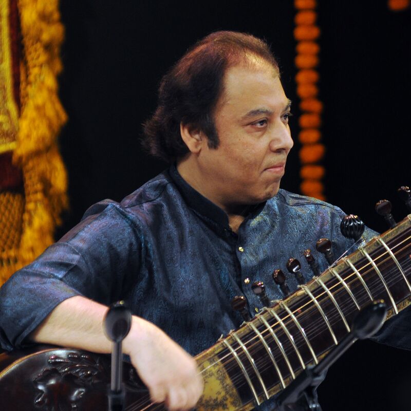 Irshad Khan playing the sitar on stage
