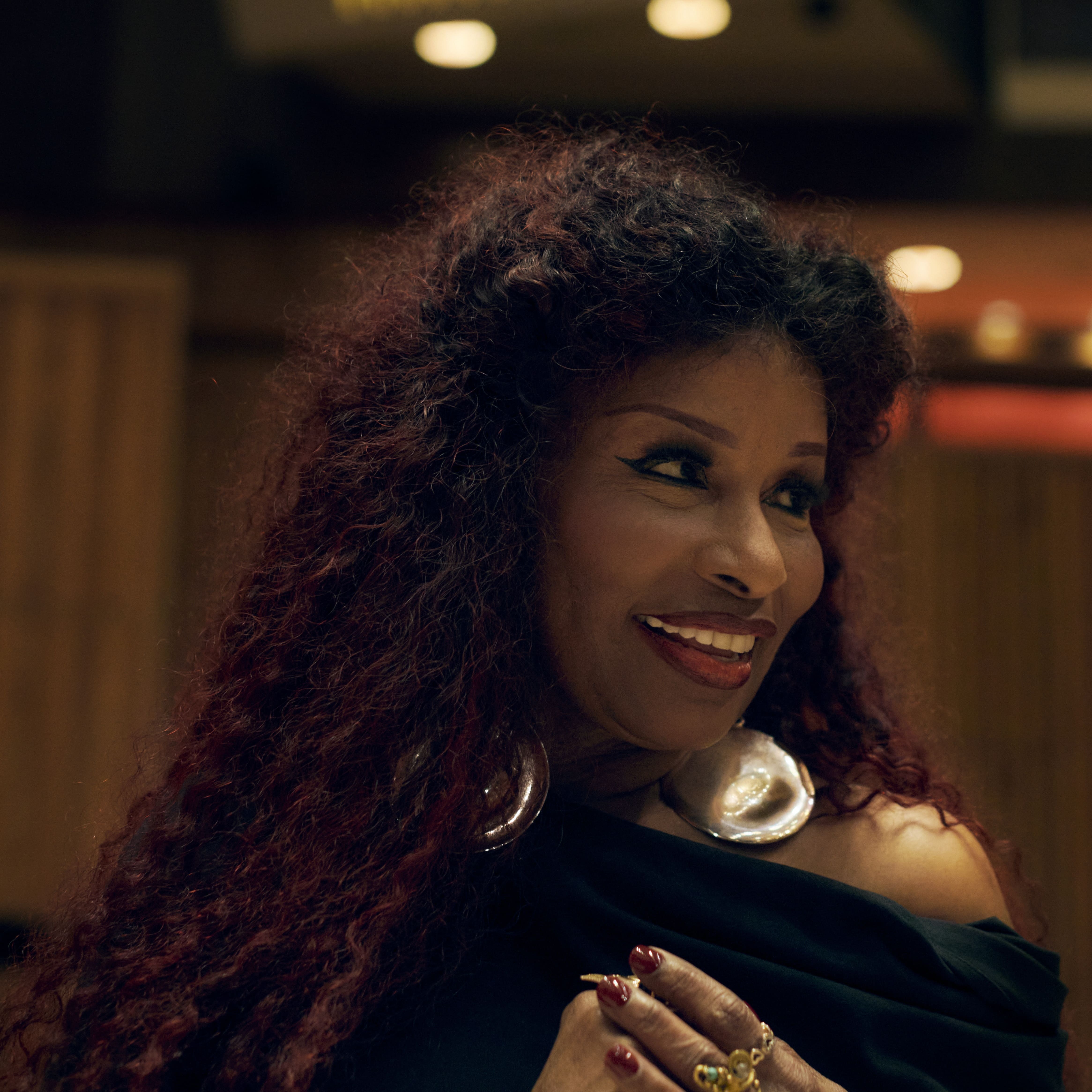 Chaka Khan is smiling and looking to her left.