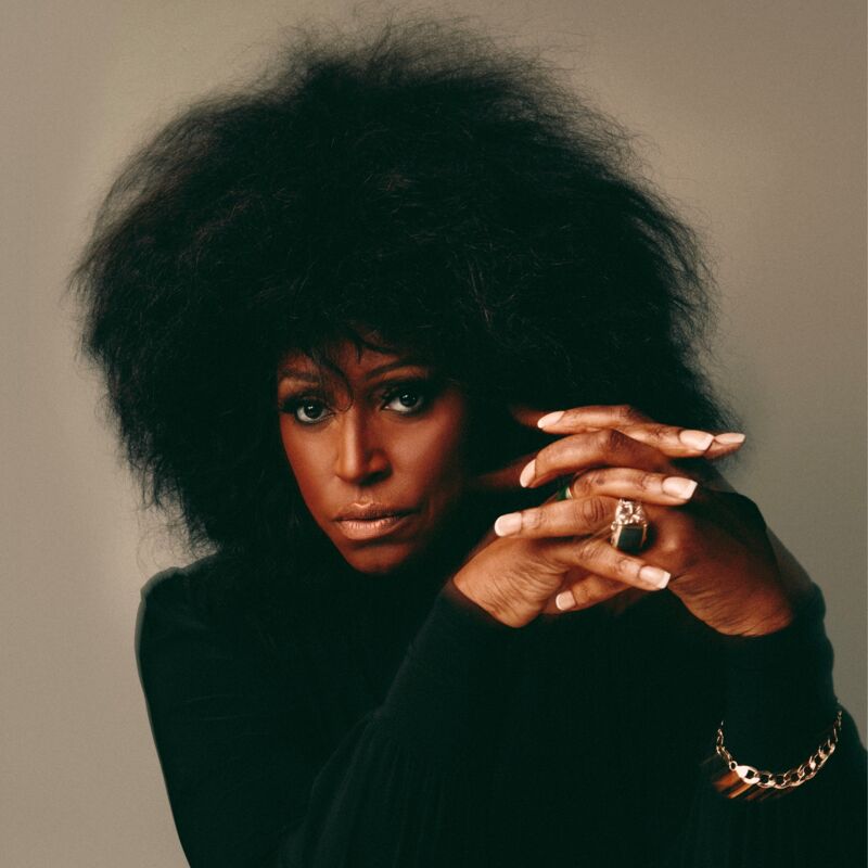 Mica Paris wearing a black shirt and interlacing her fingers together.