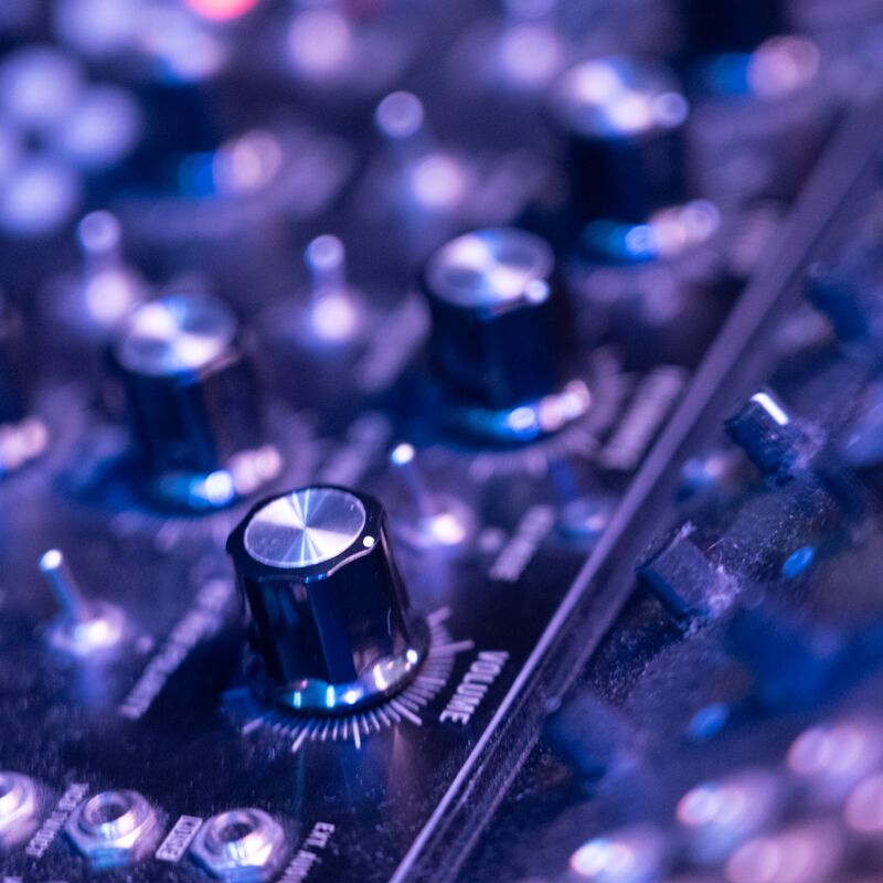 A close up shot of a synthesizer with lots of knobs and buttons