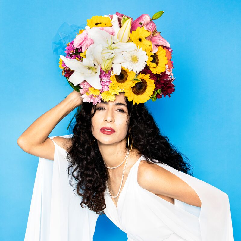 Musician Marisa Monte with flowers on her head