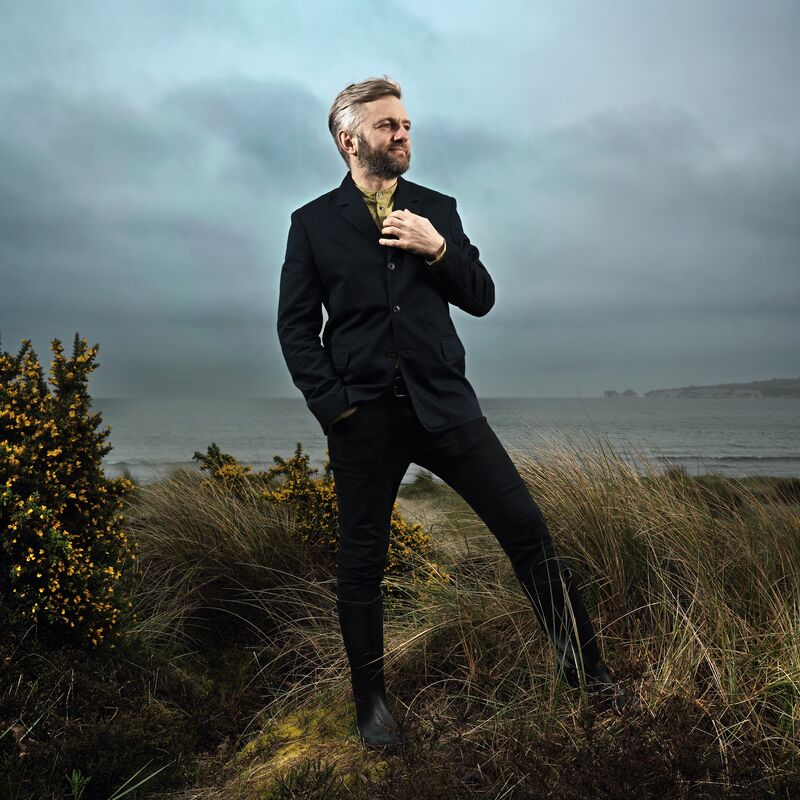 Kirill Karabits standing in the countryside and ocean