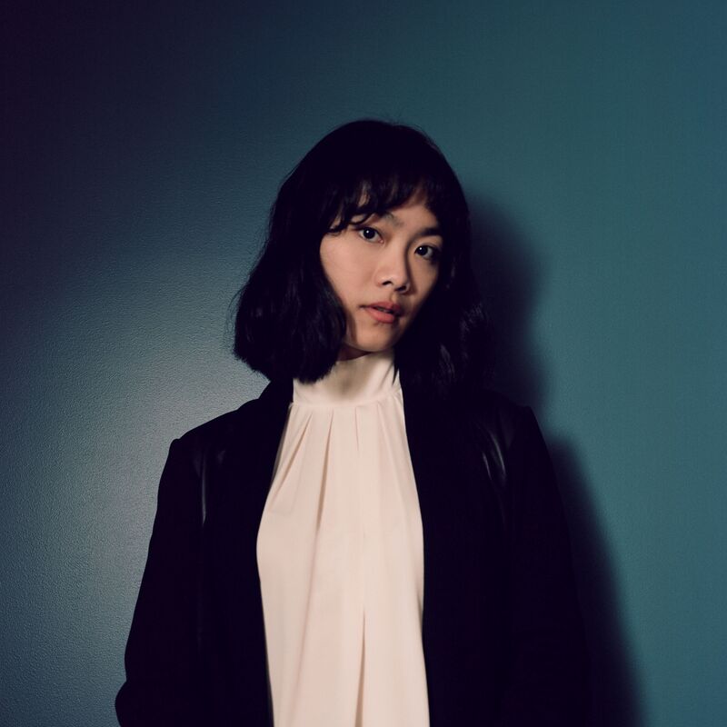 Pianist Tiffany Poon in front of a blue wall