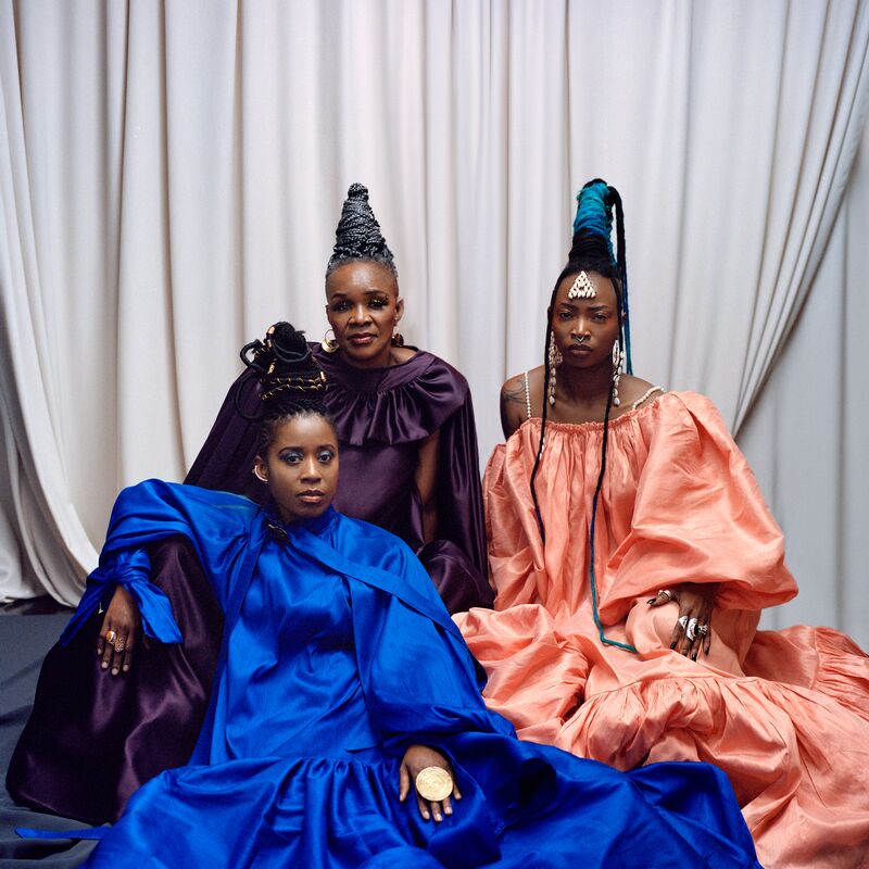 Three members of Les Amazones d'Afrique dressed in colourful clothing